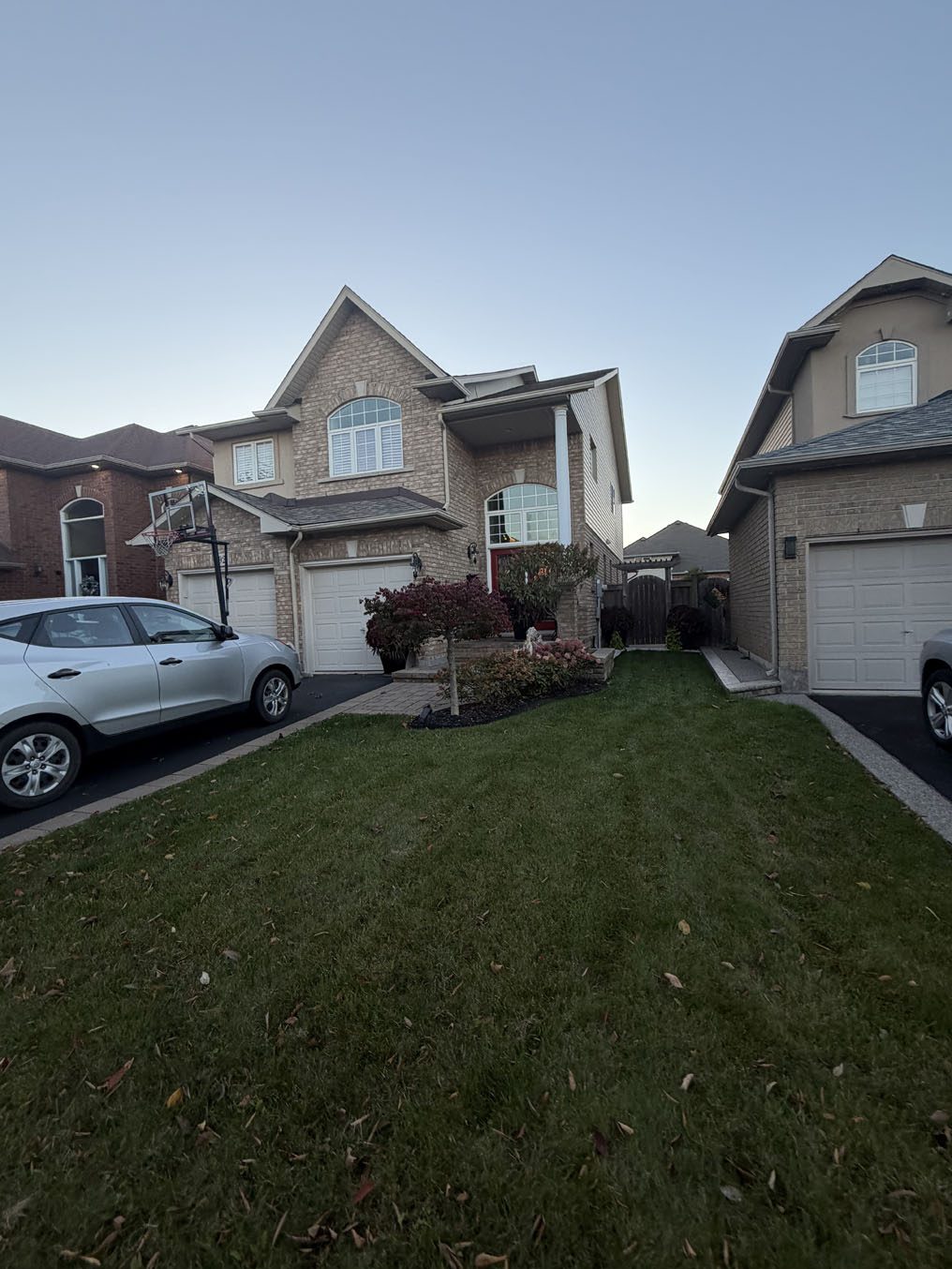 Thick green sod lawn in front of a two-car-garage home in a Hamilton subdivision