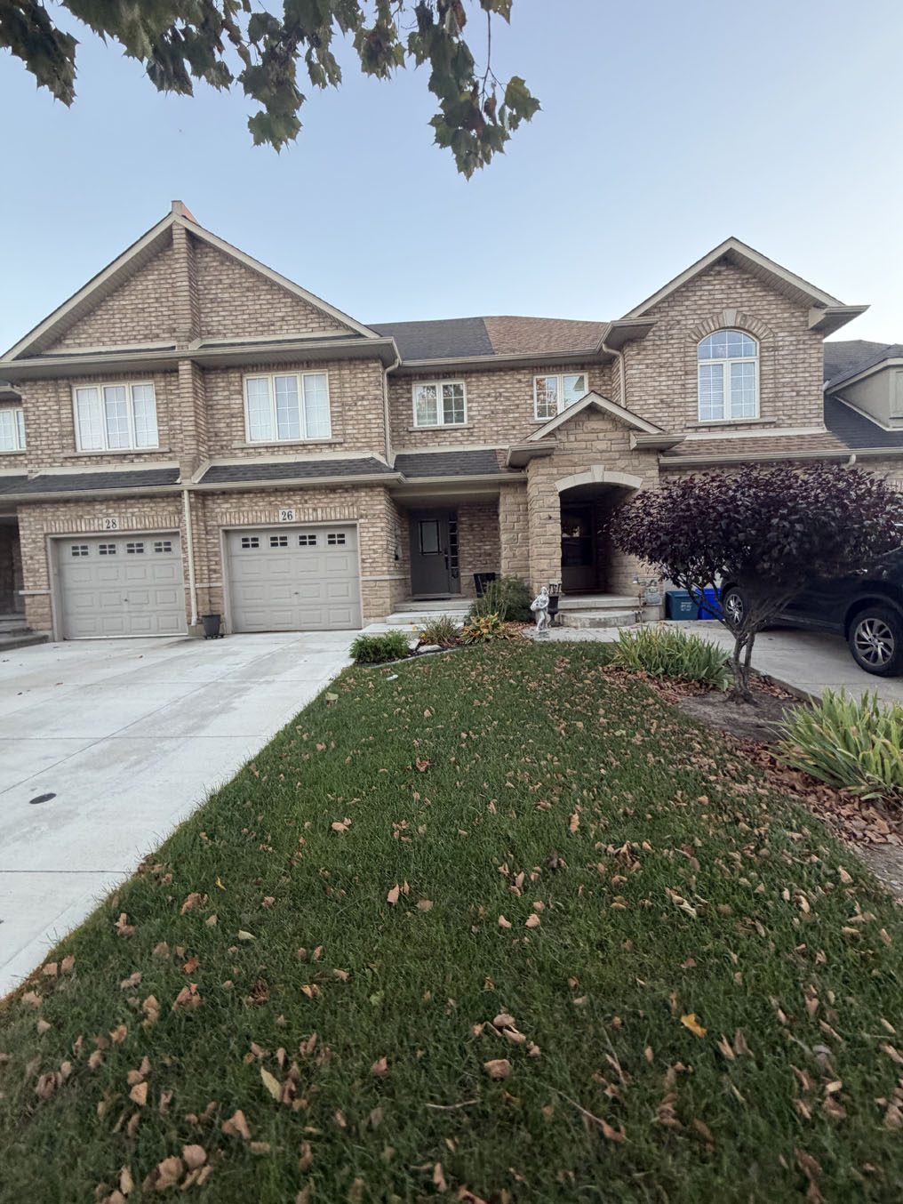 Sodded front lawns on a pair of semi-detached brick homes in Hamilton