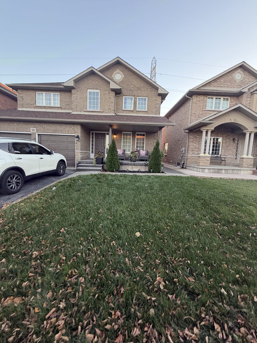 Wide, level sod front lawn on a two-storey home with a covered porch in Hamilton